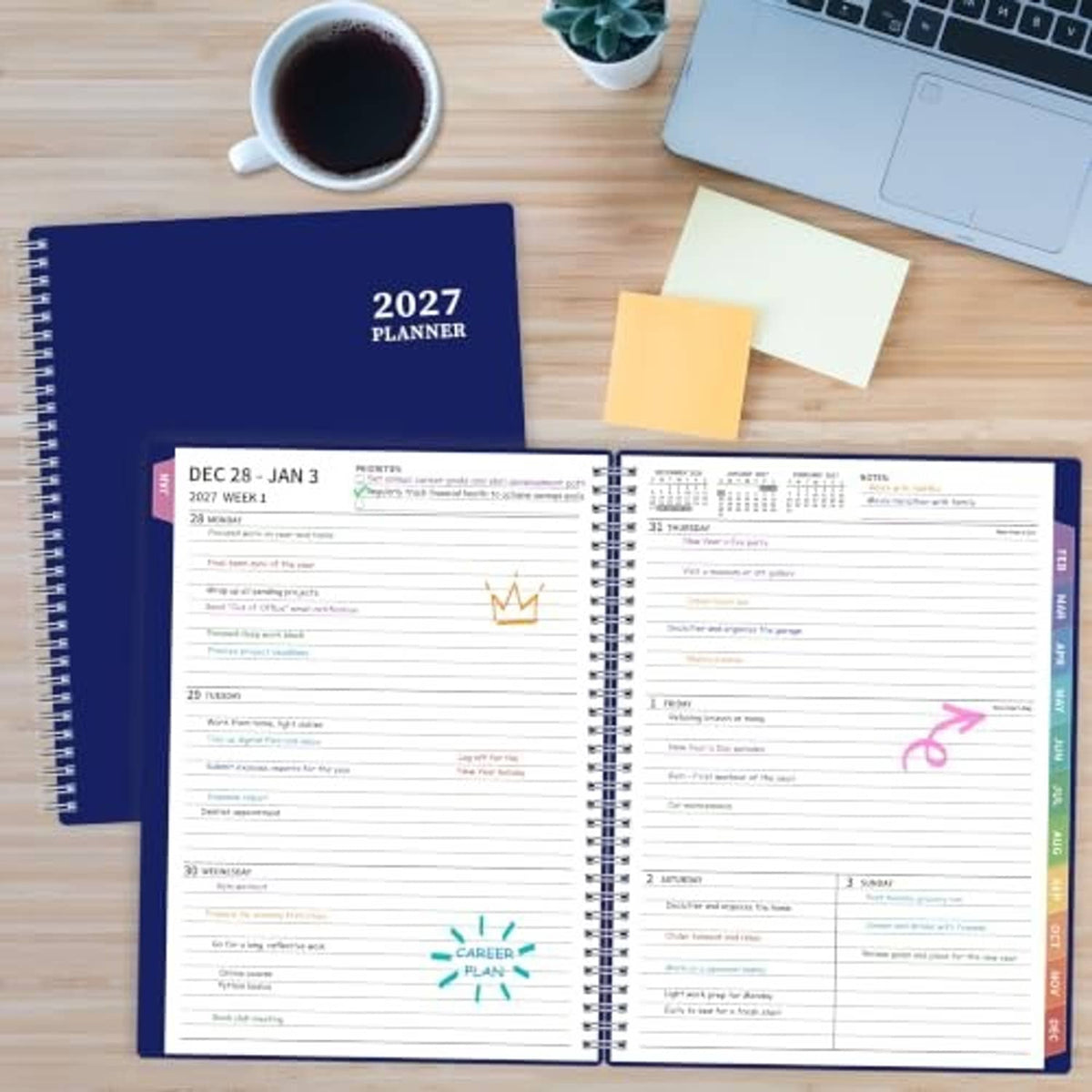 2027 planner open on a wooden desk with weekly pages visible beside sticky notes.