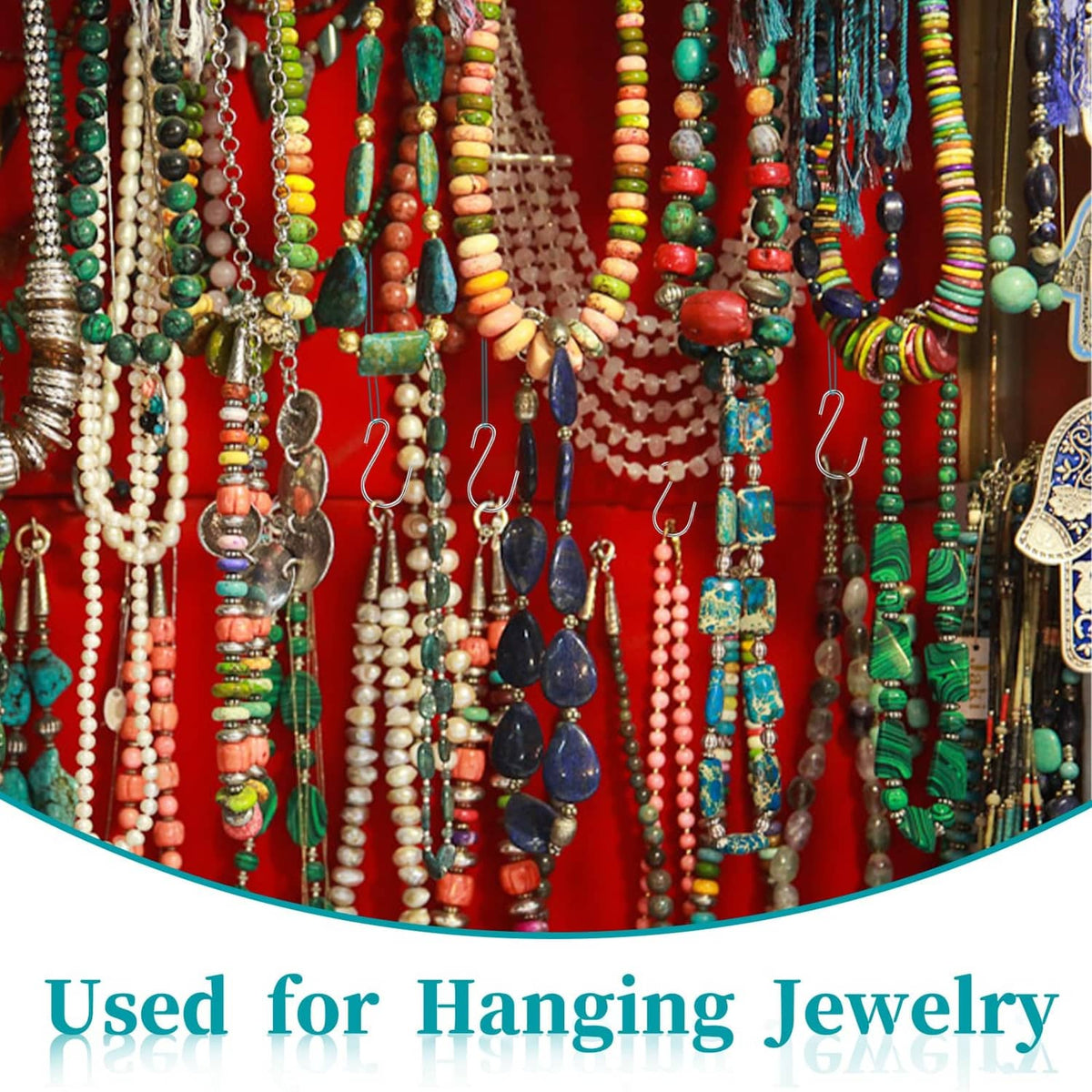 Metal S hooks hanging necklaces and bracelets on a jewelry display rack