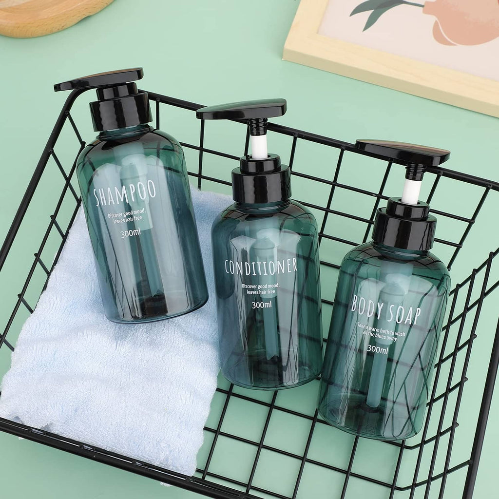 Three teal liquid soap, shampoo, and conditioner bottles on a wire caddy with black pumps