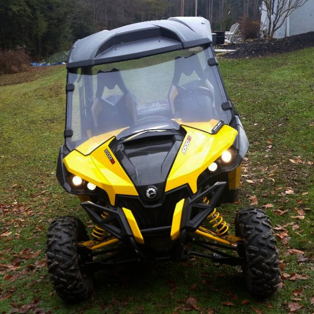 UTV front windshield with clear tinted panel and black side clamp mounts.