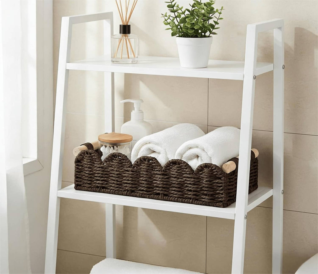 Brown woven toilet paper storage basket with two folded towels and beige rope accents
