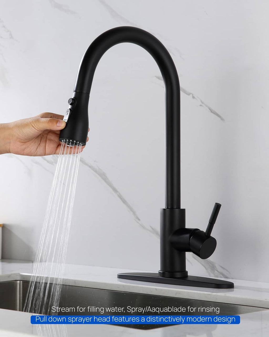 Matte black pull-down sprayer head spraying water from the sink faucet