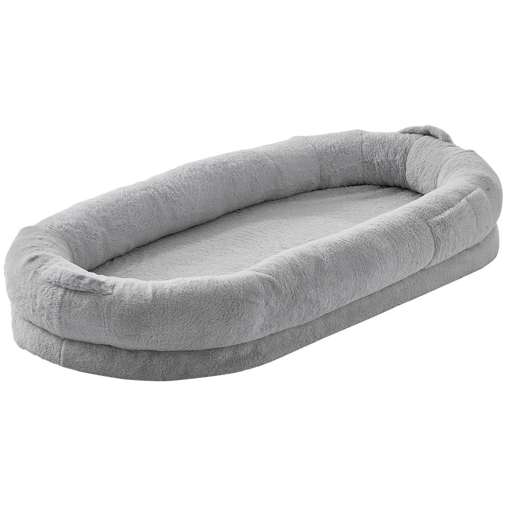 Light gray plush dog bed with faux rabbit fur, oval cushion with raised edges