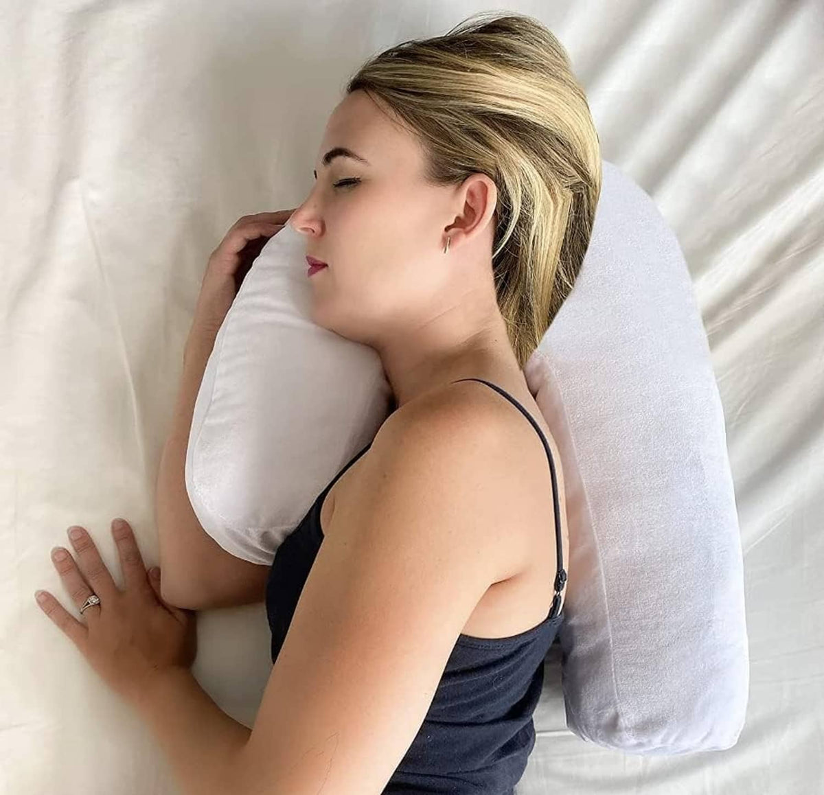 Side sleeper pillow with ear hole, white U-shaped cushion cradling head and neck
