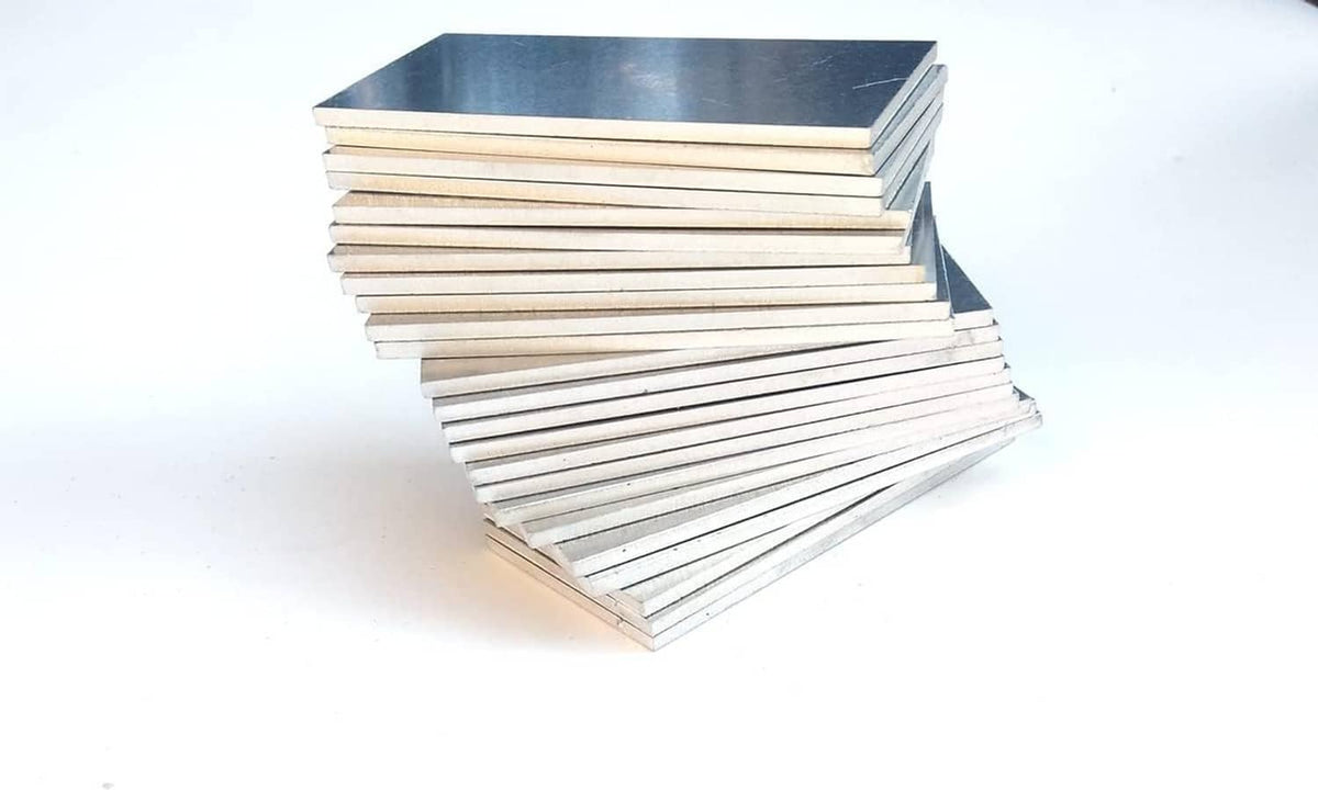 Silver aluminum coupon sheet stack with flat, reflective top plate and layered sides.