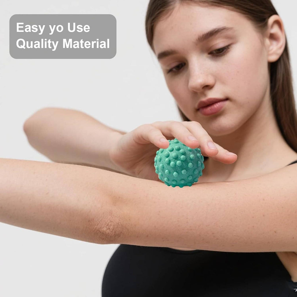 Textured teal foot massage ball used for self-massage on the upper arm