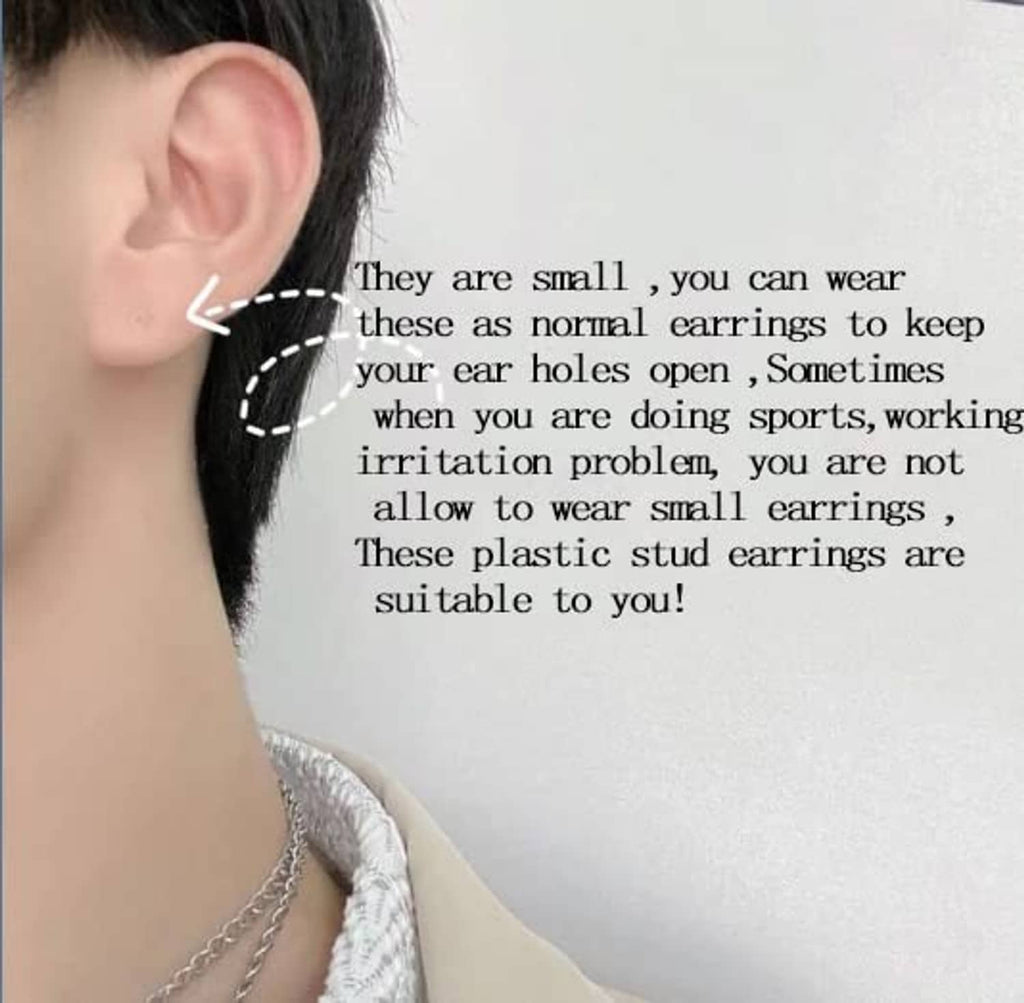Clear plastic stud earrings on ear, tiny transparent posts with backs