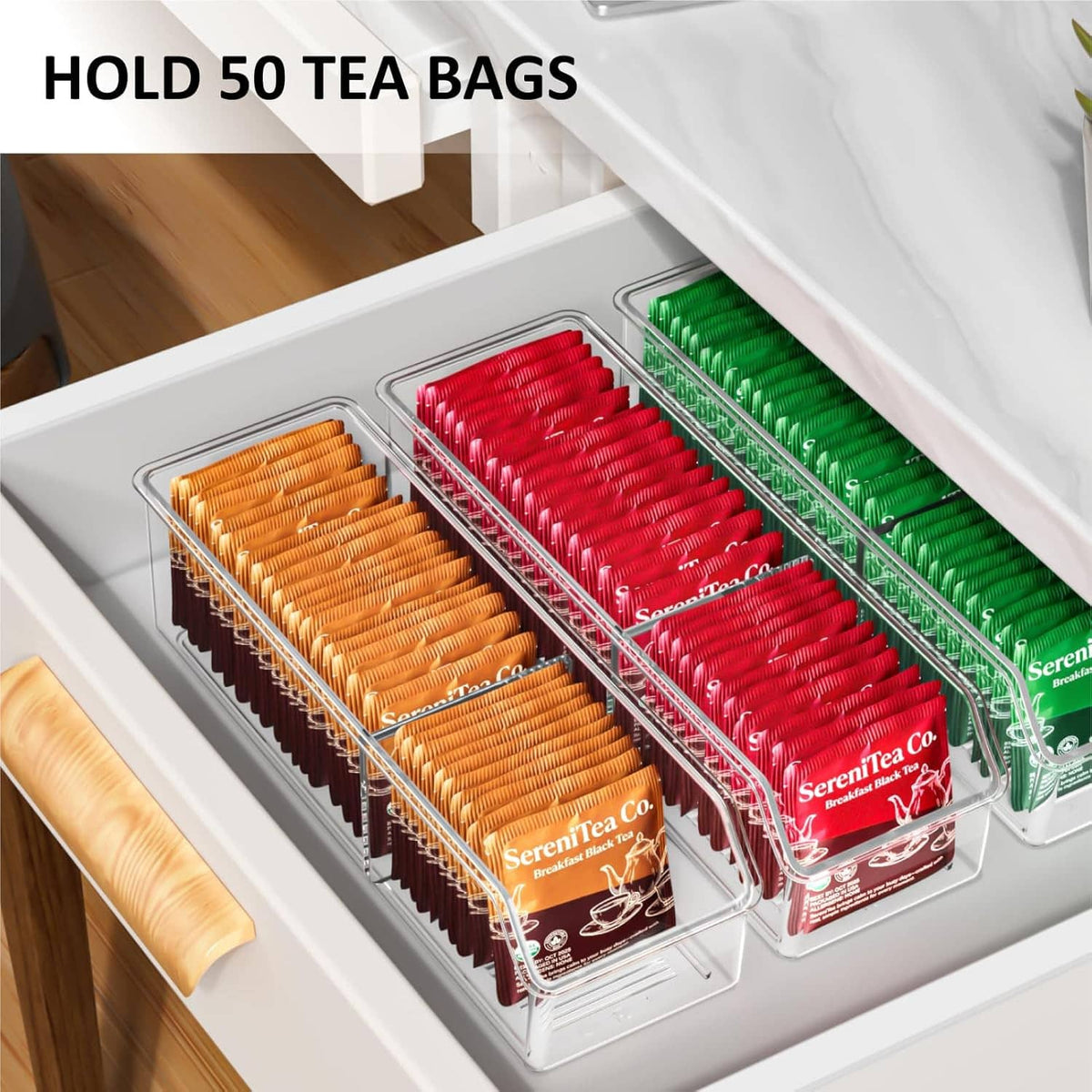 Clear tea bag organizer drawer bin with three compartments holding orange, red, and green tea bags