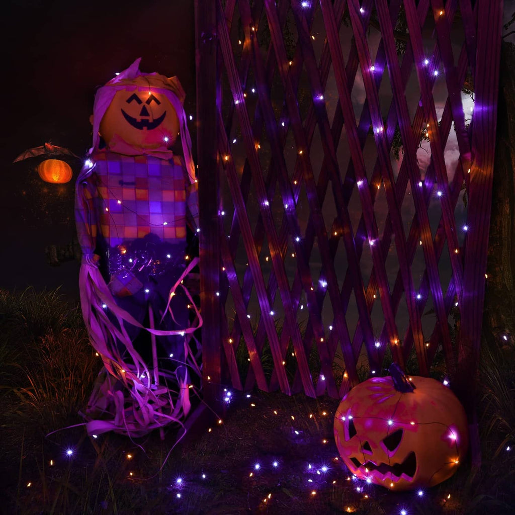 Solar string lights with purple glow around jack-o'-lanterns and a fence outdoors