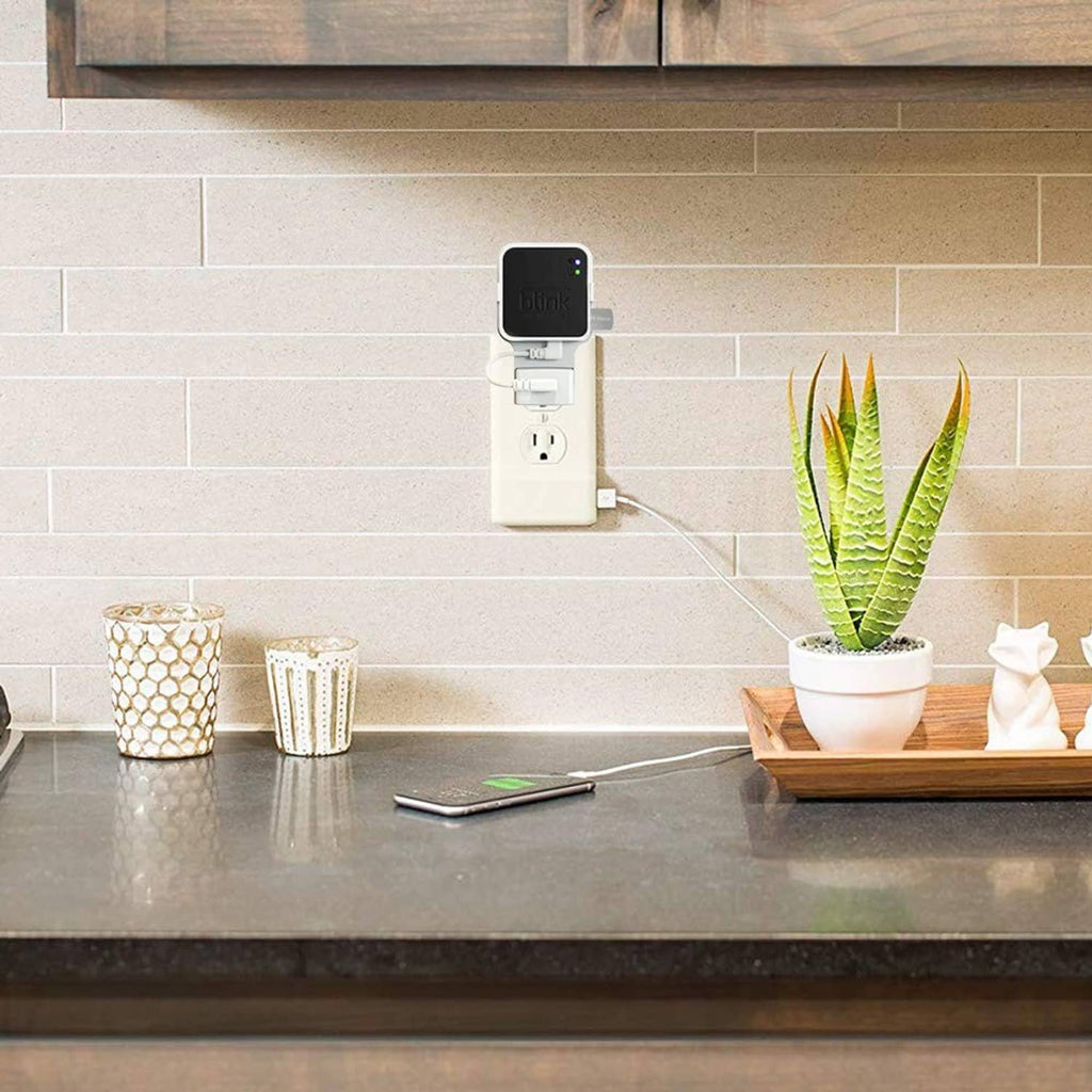 Wall-mounted white outlet adapter with Blink Sync Module 2 unit and USB thumb drive