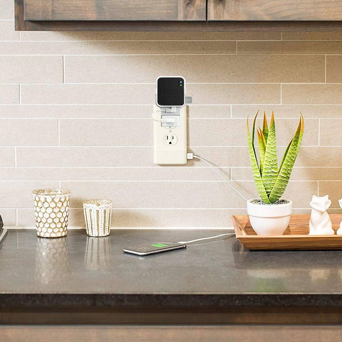 Wall-mounted white outlet adapter with Blink Sync Module 2 unit and USB thumb drive