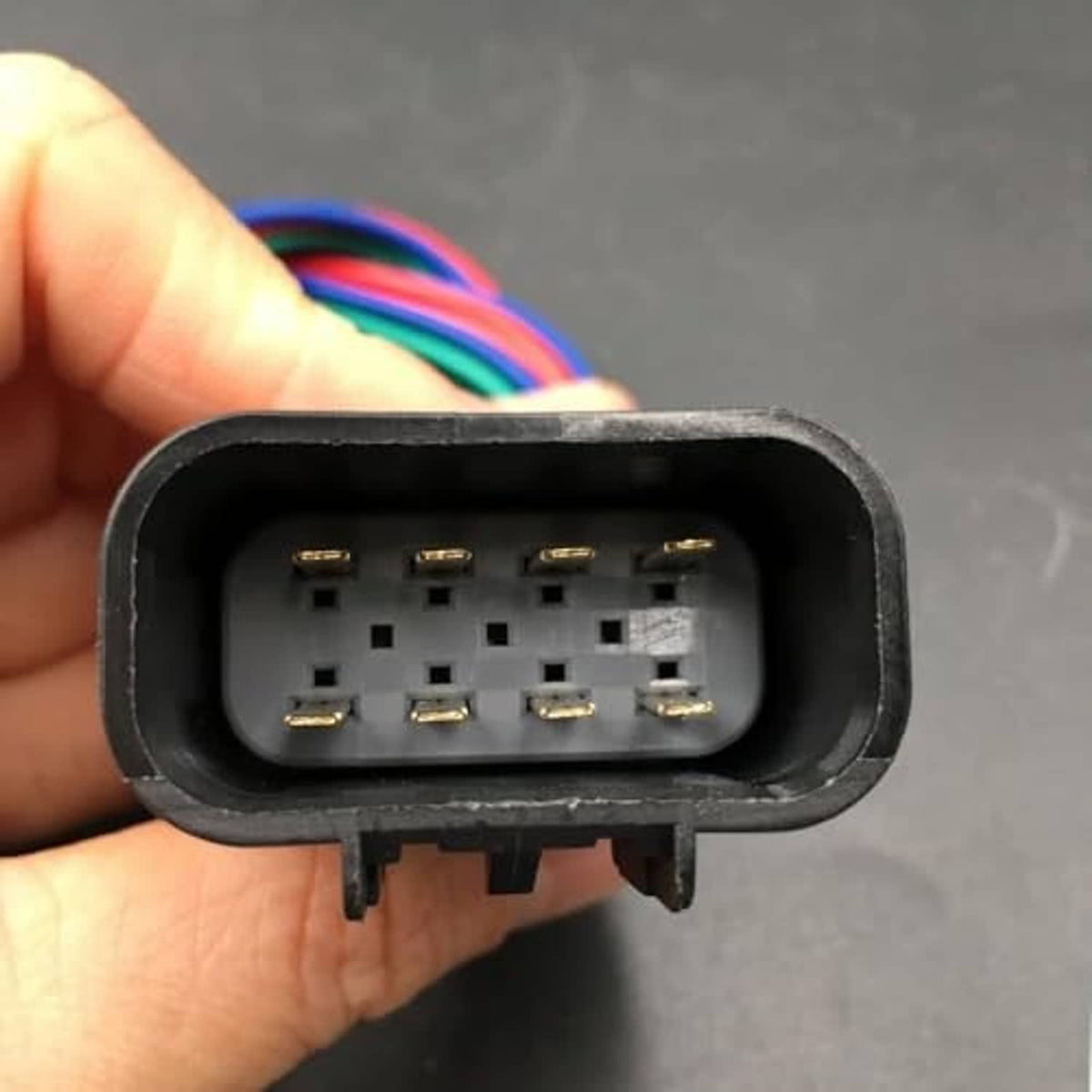 Vehicle connector socket showing eight gold-plated pins inside black housing