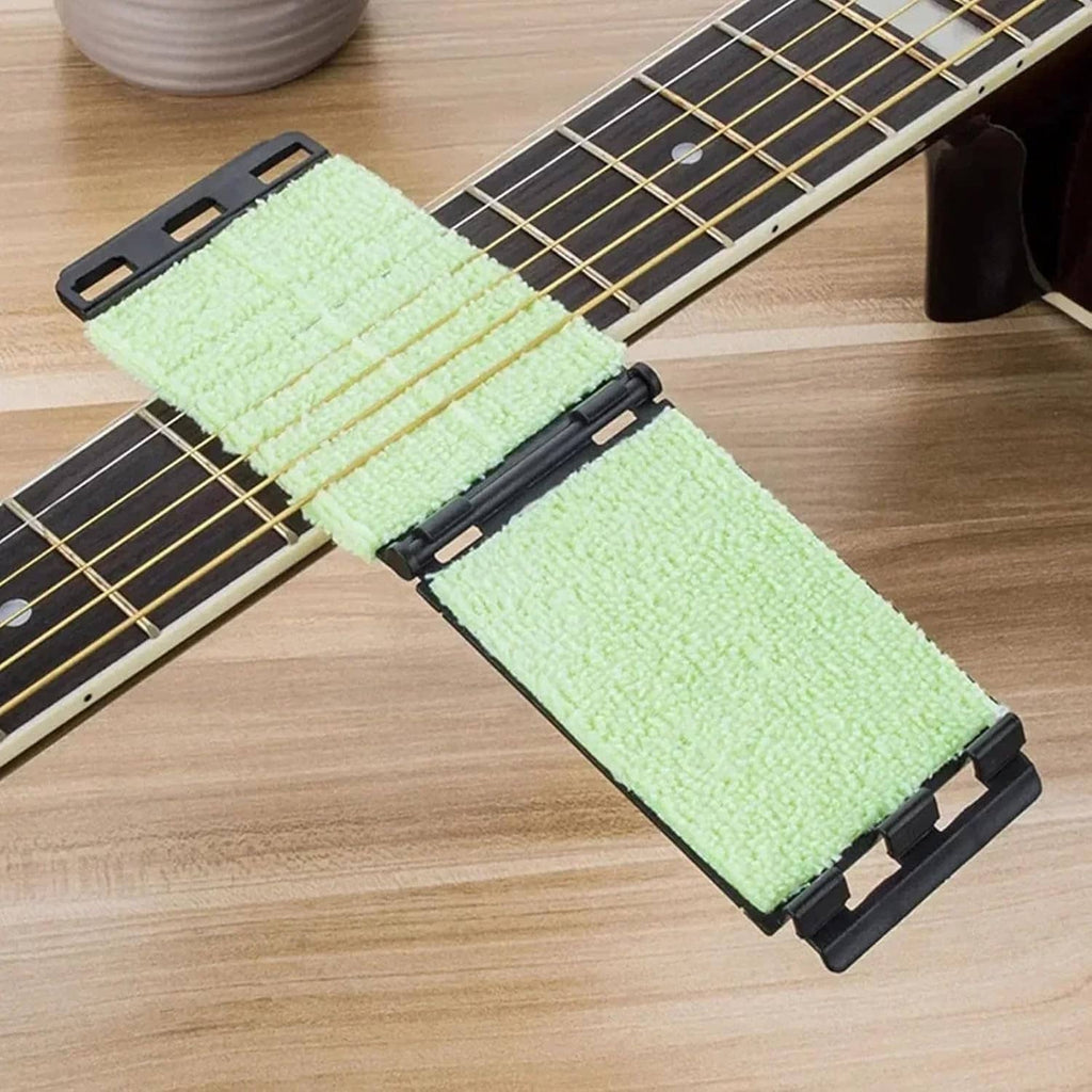 Guitar fretboard cleaning tool with two green cloth pads on black holders