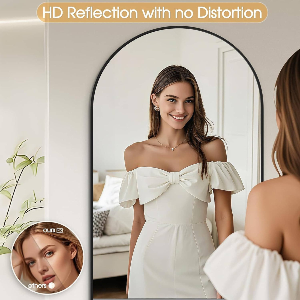 Arched mirror with black frame, close reflection of a woman facing the mirror.