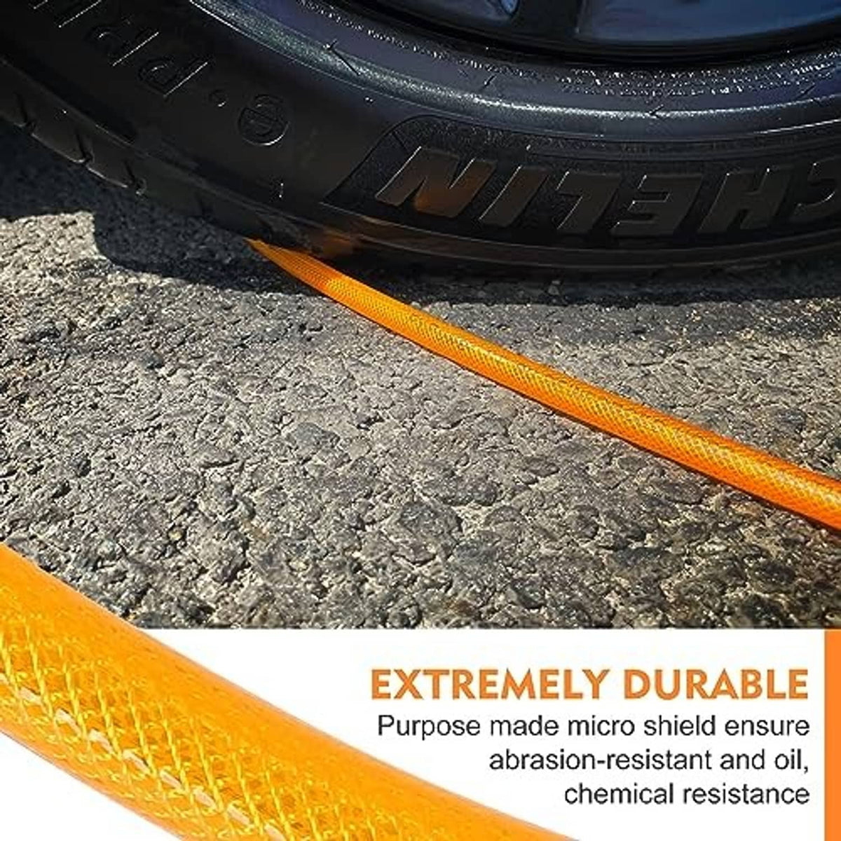 Orange air hose laid along ground with black ribbed section near vehicle