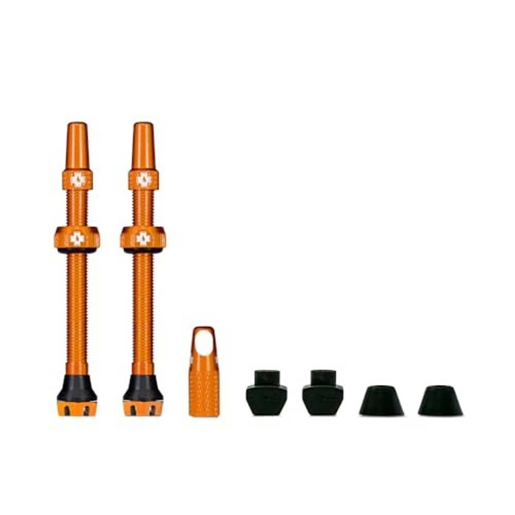 Orange Presta tubeless valve stems with caps and core removal tool, shown together.