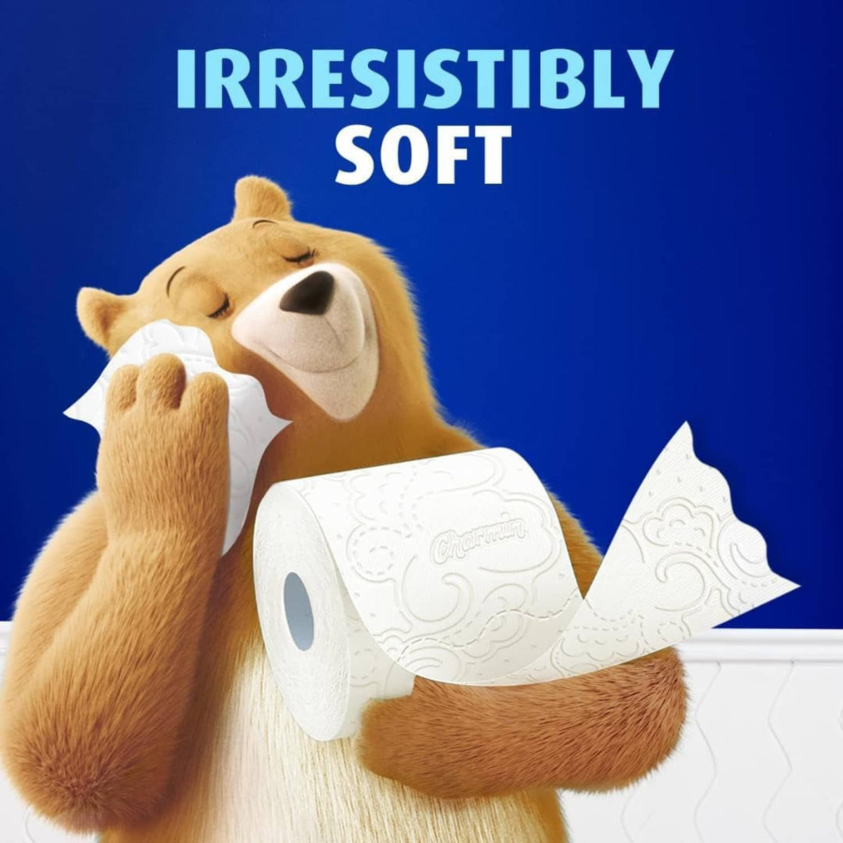 Charmin Ultra Soft toilet paper rolls held with bear graphic