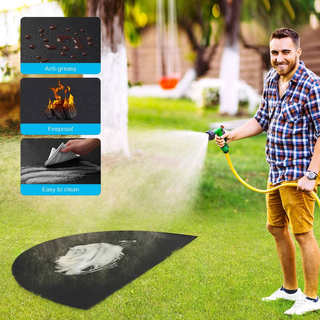Black half-round fireplace mat outdoors with water spray, for easy cleaning