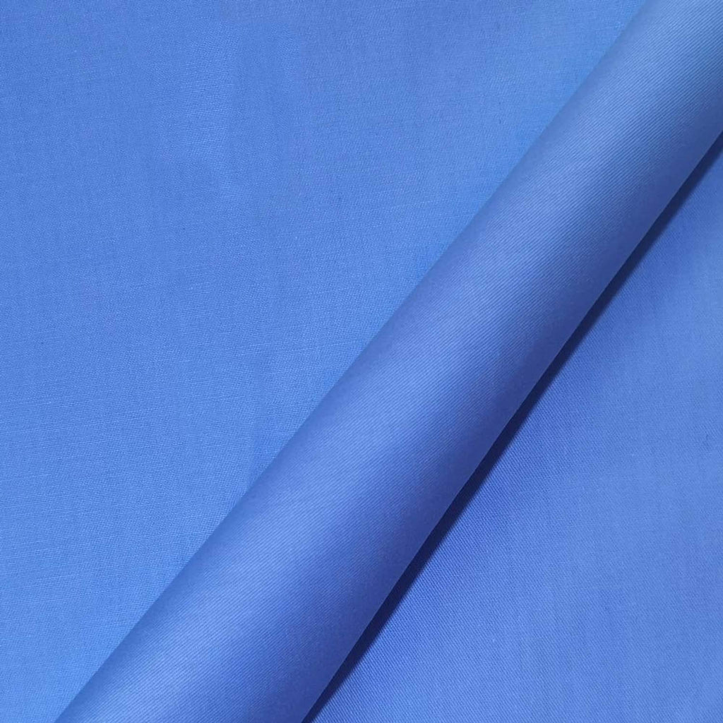 Close-up of smooth solid blue cotton fabric with subtle woven texture