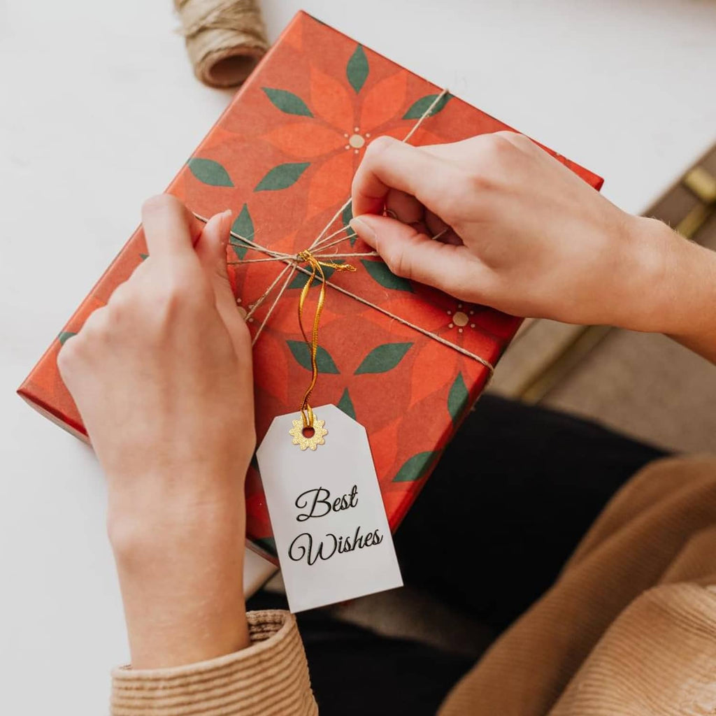 Gift wrapping with a small star reinforcement piece attached to a tag