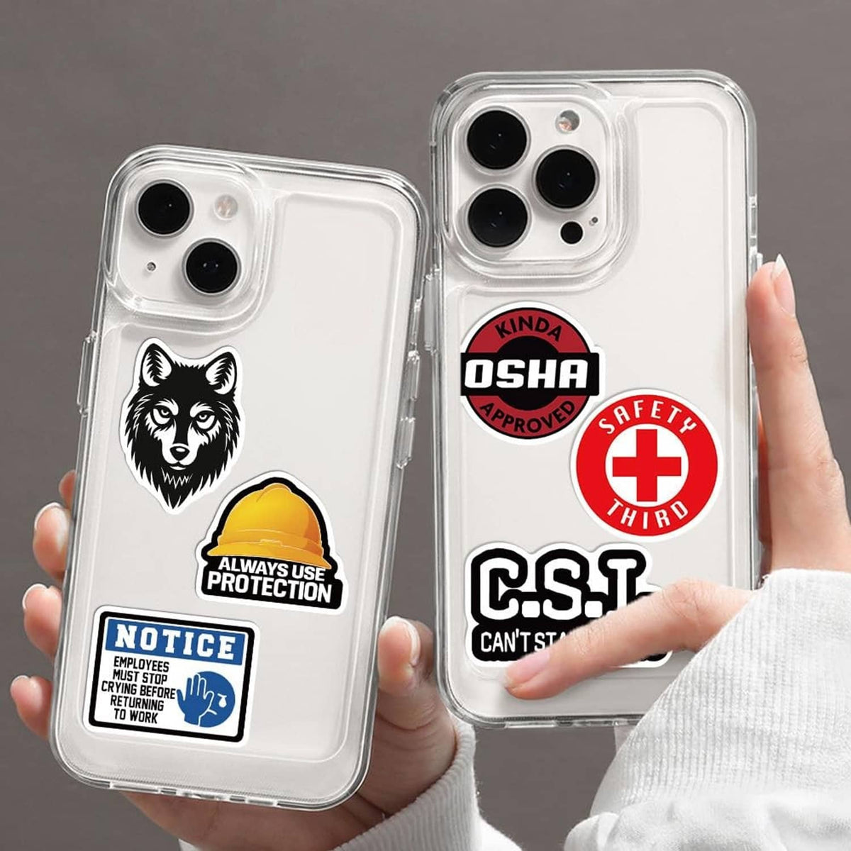 Hard hat stickers on clear phone cases: wolf logo and OSHA badge with red cross