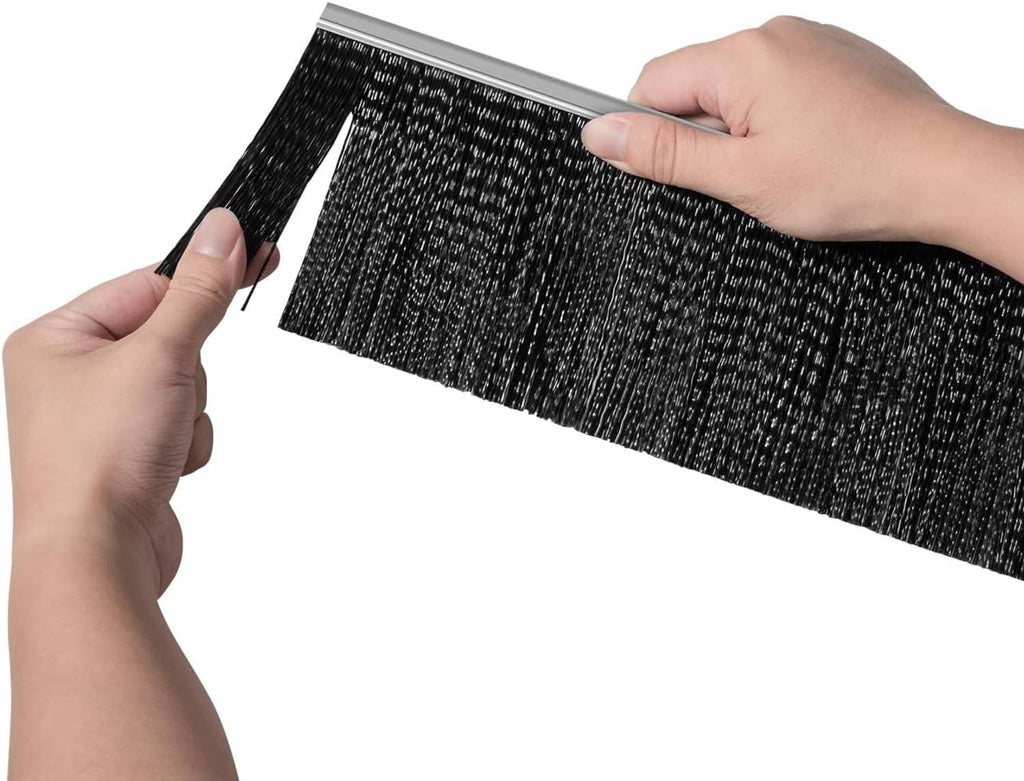 Lawn sweeper replacement brush held in hands, showing black bristles on gray bar
