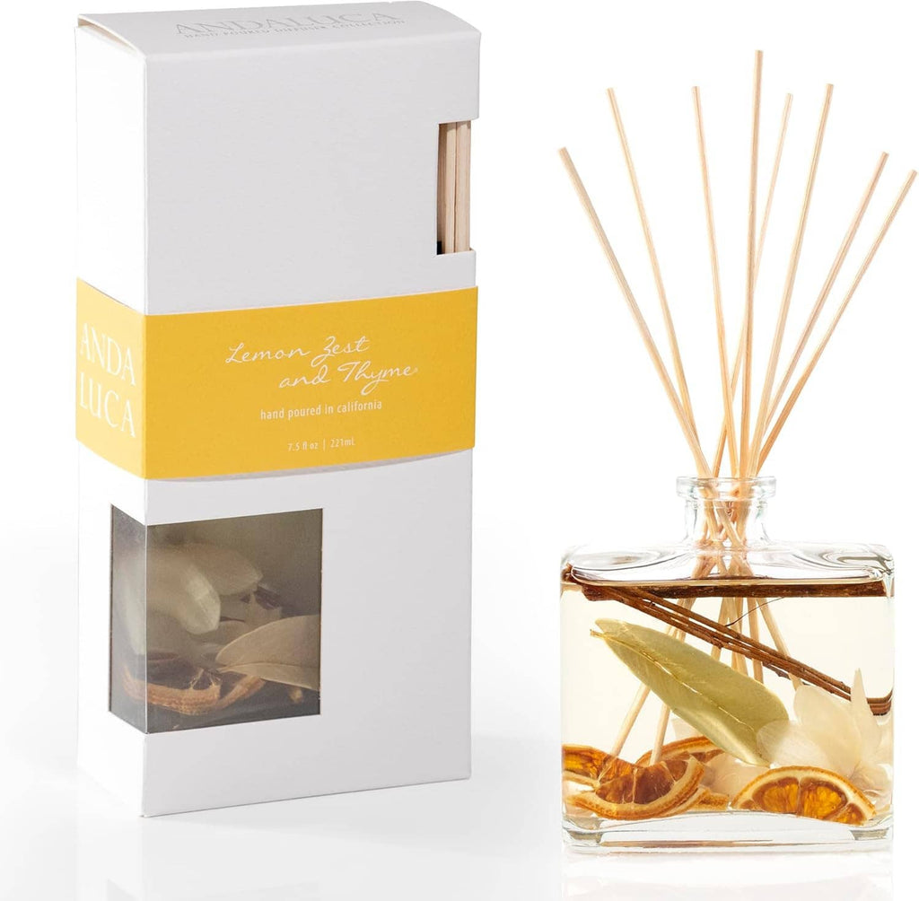 Reed diffuser set with clear bottle, tan reeds, citrus slices, and white gift box