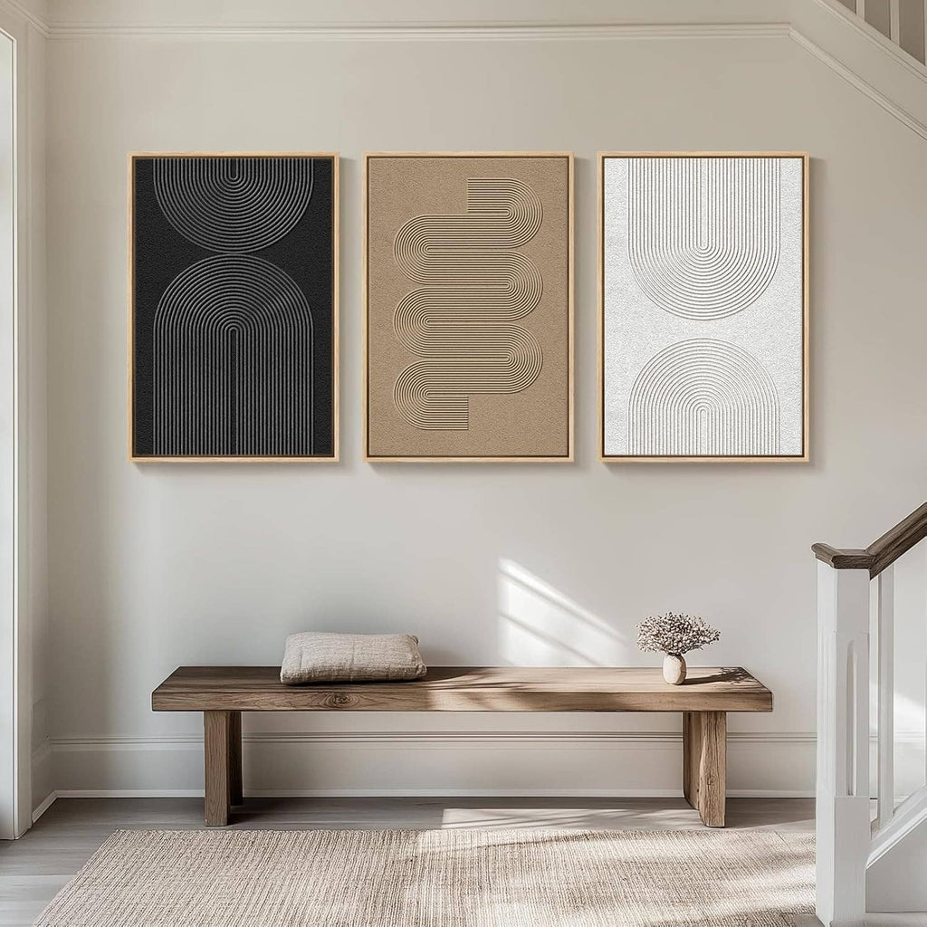 Three framed abstract line art panels with arched lines in black, beige, and light gray