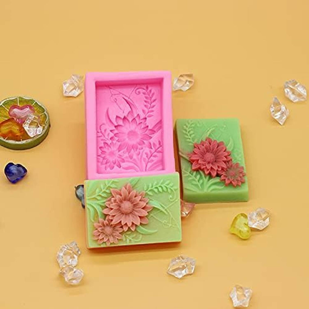 Square silicone soap molds with embossed floral rosette designs, pink and green