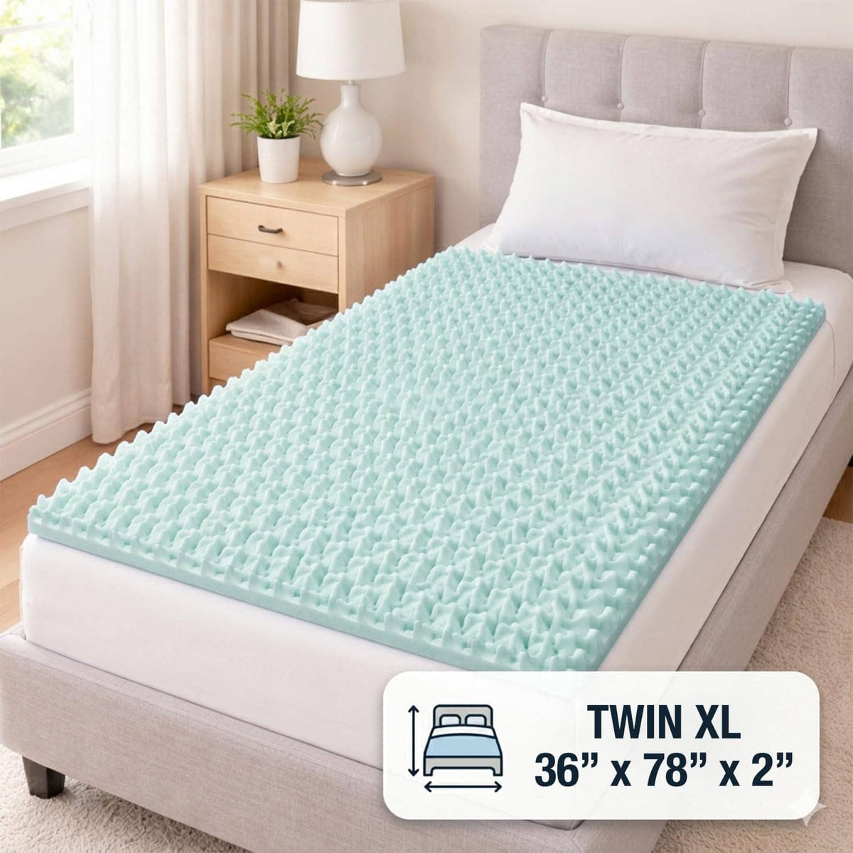 Twin XL egg-crate foam mattress topper in light teal on a bed top surface.