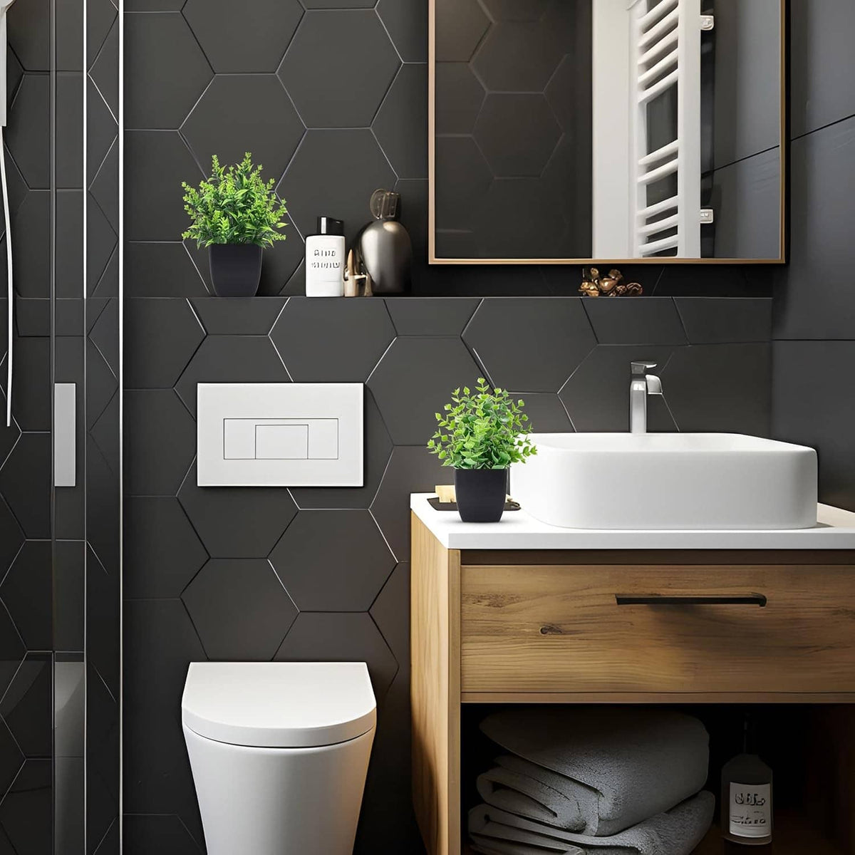 Small faux plant in black pot with bright green leaves for bathroom counter