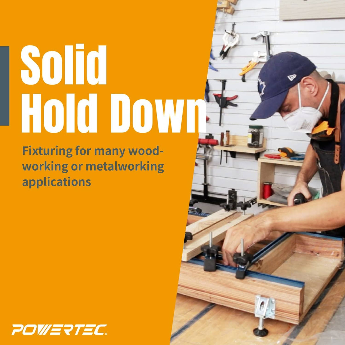 Blue and black hold-down clamp securing a wood workpiece in workshop