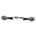 Pair of clear-lens motorcycle turn signal lights with ribbed black housings and wiring