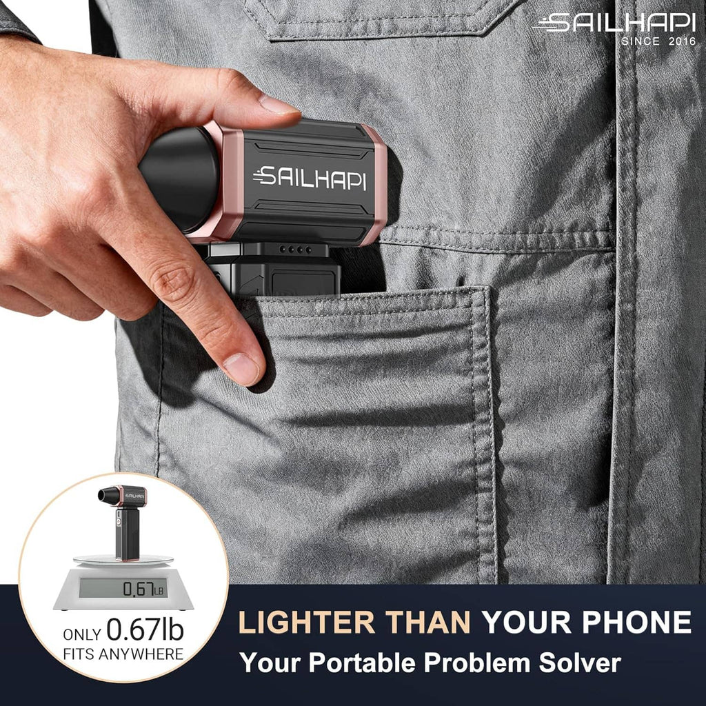 Pocket-sized cordless air duster held in hand with compact rose-and-black body