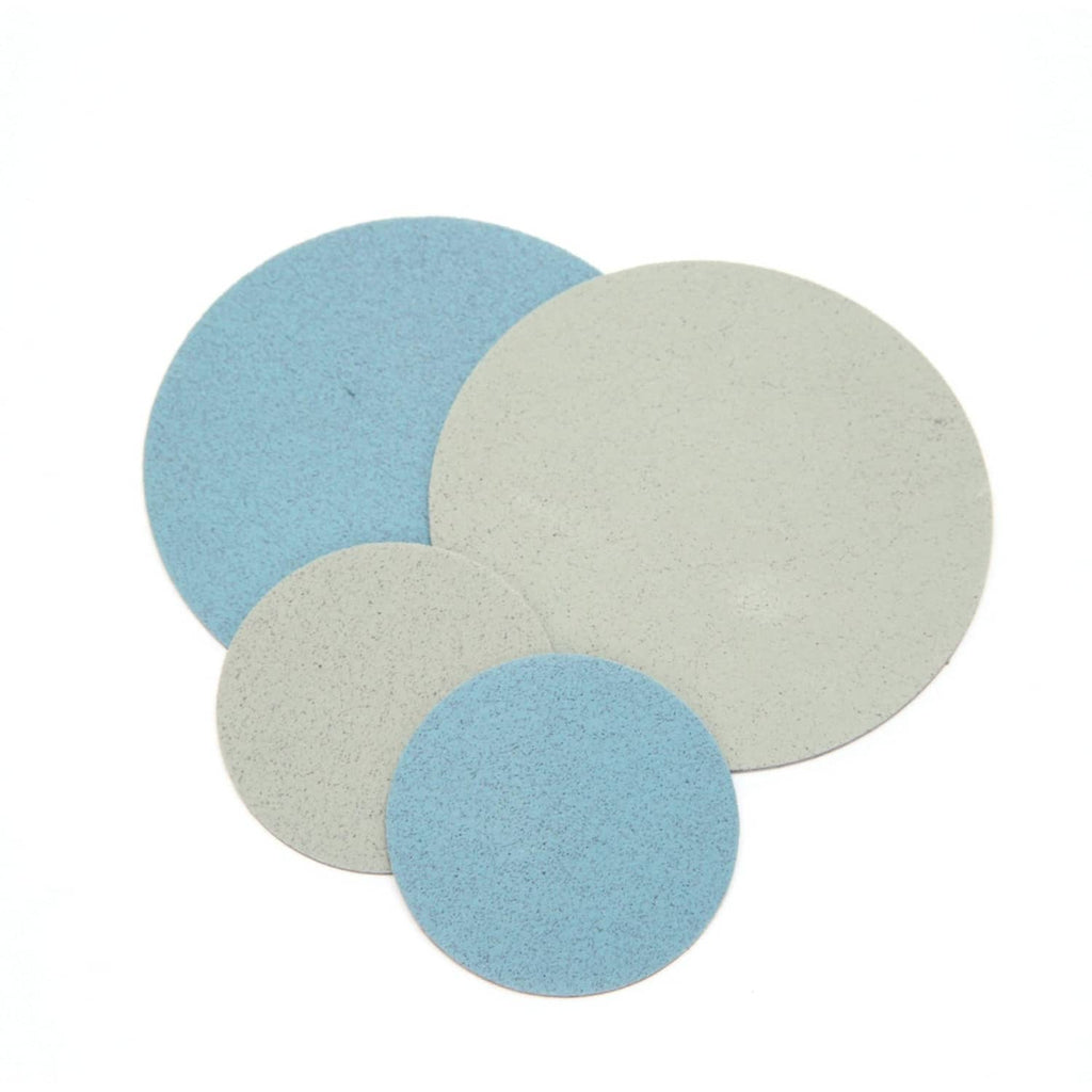 Round foam sanding discs stack, blue and gray and off-white, abrasive pads