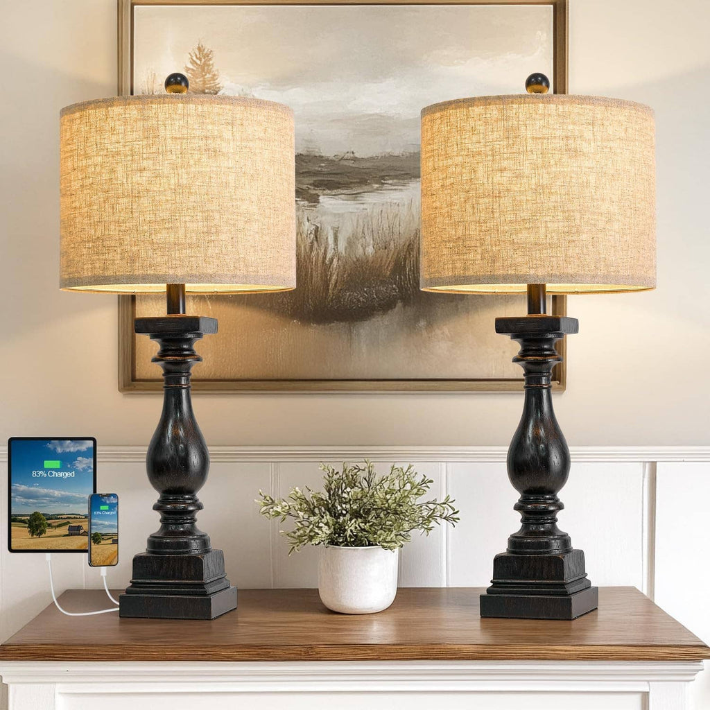 Two table lamps with beige drum shades and dark bases, USB charging devices on top