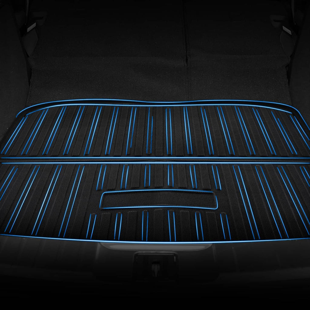 Black floor mat surface with raised grooves and blue directional stripes across it