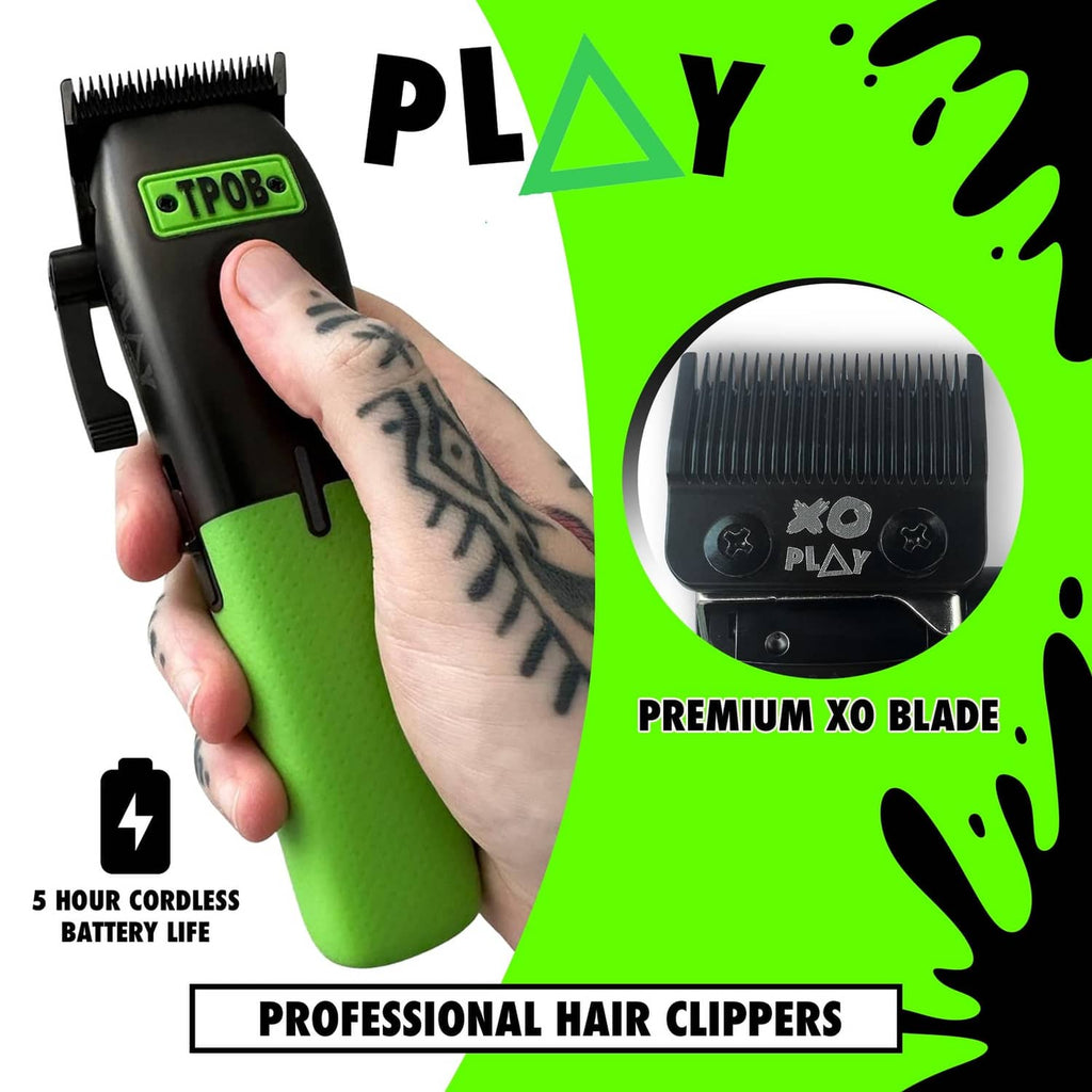 Men's cordless hair clipper held in hand, black body with green lower section