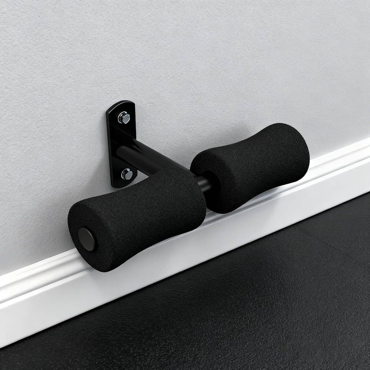 Wall-mounted sit-up foot holder with two black foam pads on a silver bar.