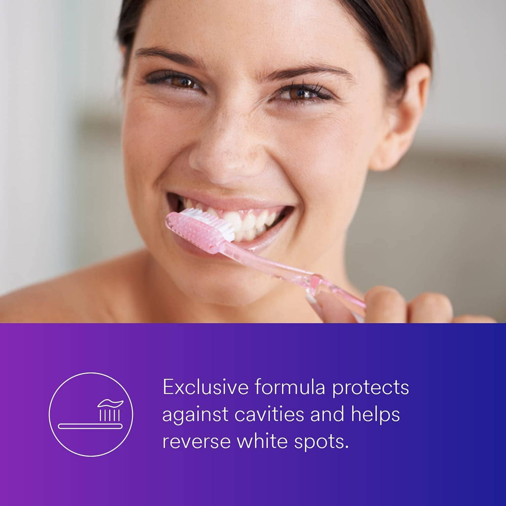 Anti-cavity fluoride toothpaste on toothbrush, close-up smile while brushing