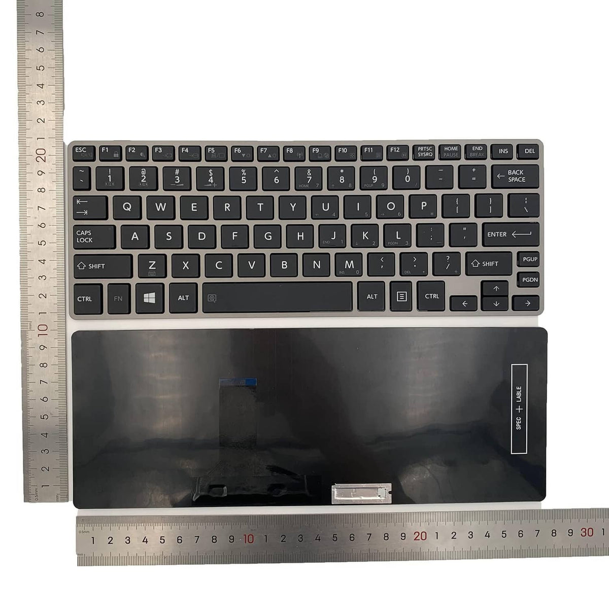 Black laptop replacement keyboard with key legends and bottom cutouts