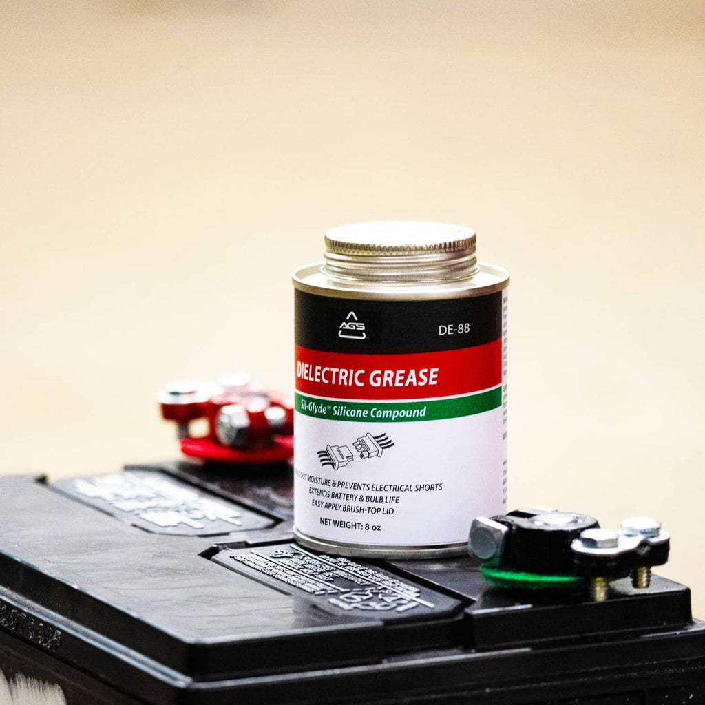 Dielectric silicone grease can on automotive fuse or relay cover