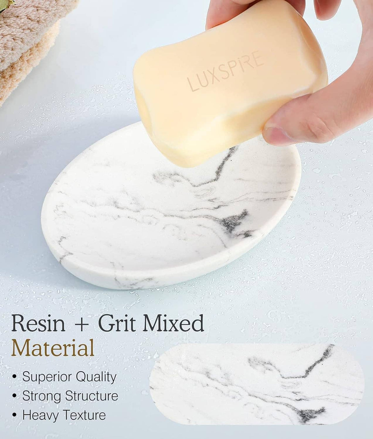 White marble oval soap tray with hand holding a bar of soap above it