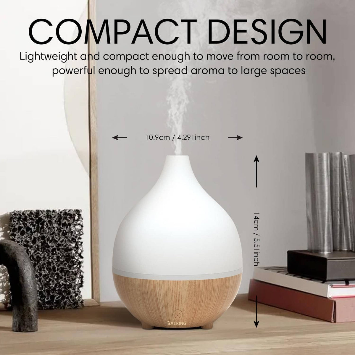 Compact essential oil diffuser, white top and light wood base emitting mist