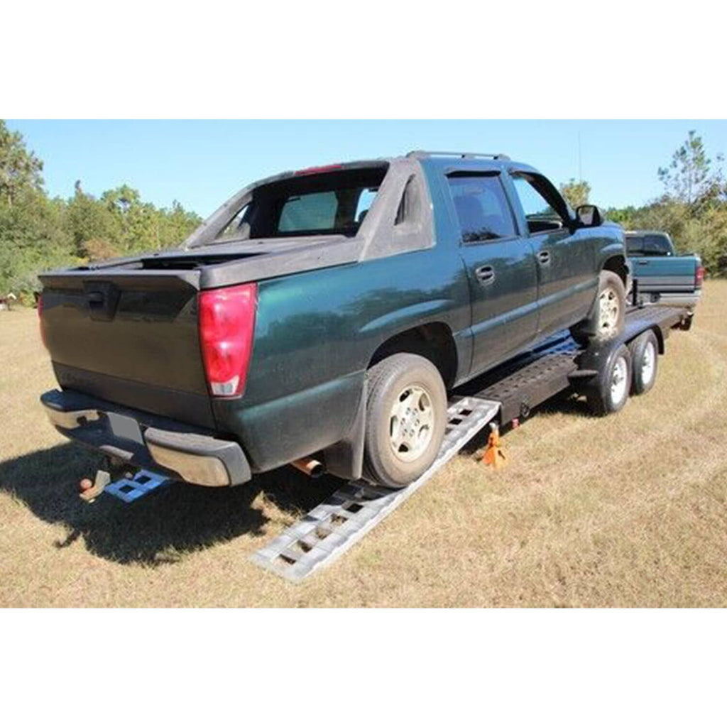 Aluminum truck trailer ramps under a pickup truck rear tires