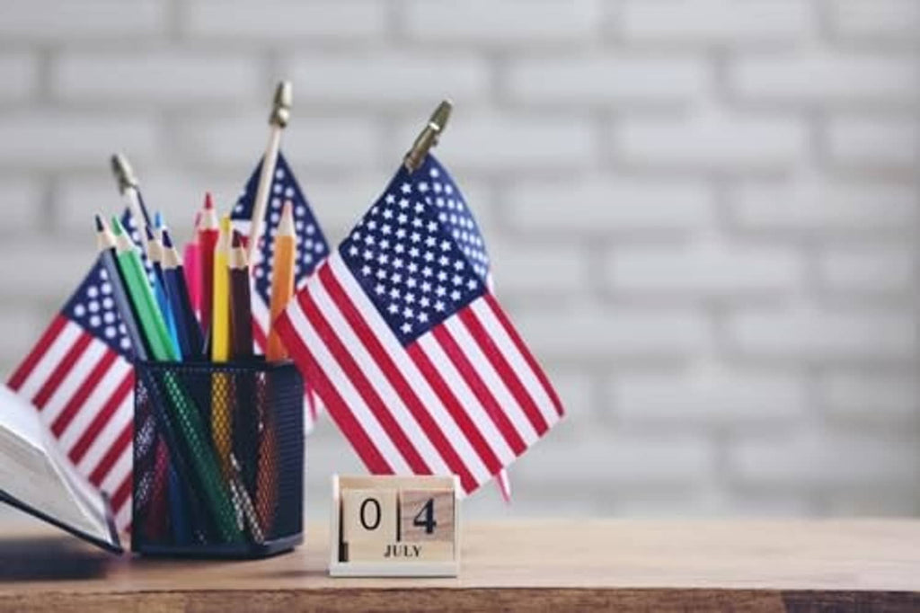U.S. stick flag on a wooden pole, red white stripes and blue star field