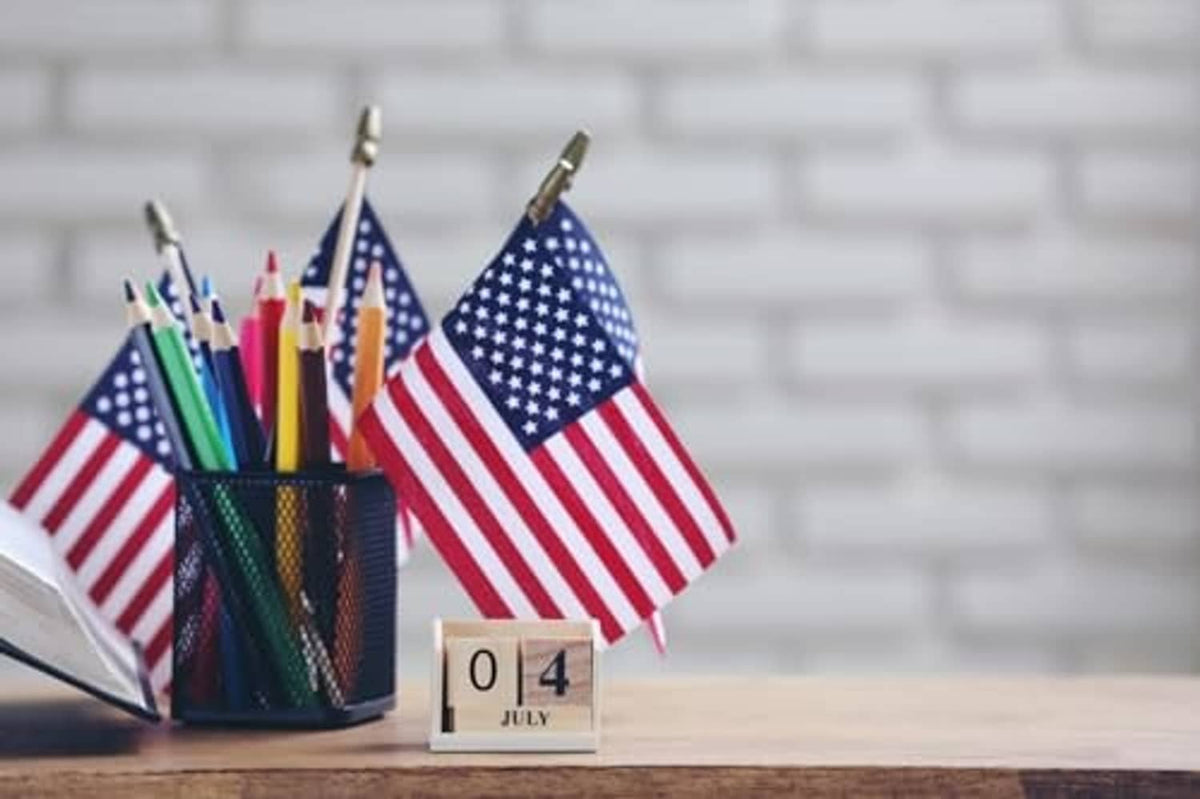 U.S. stick flag on a wooden pole, red white stripes and blue star field
