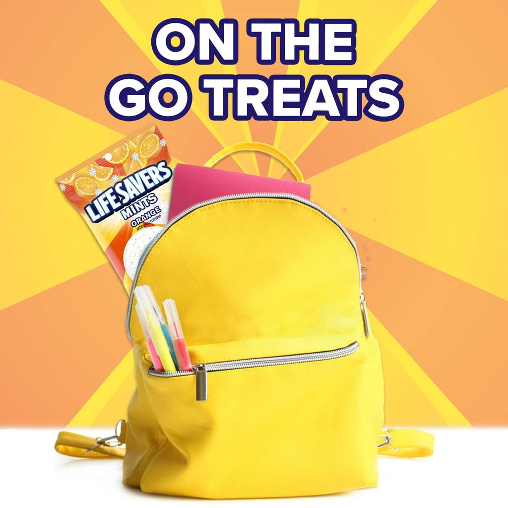 Orange-flavored mint candy bag placed on a yellow backpack