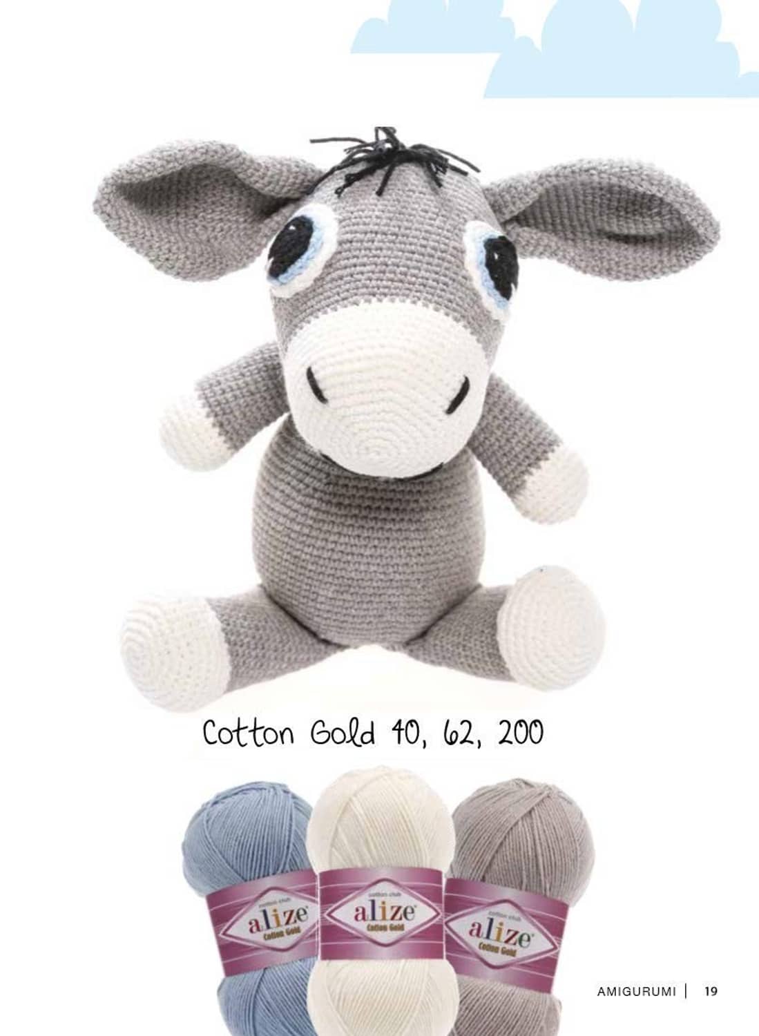Cotton Gold yarn in gray and light blue colors, shown with amigurumi cow plush