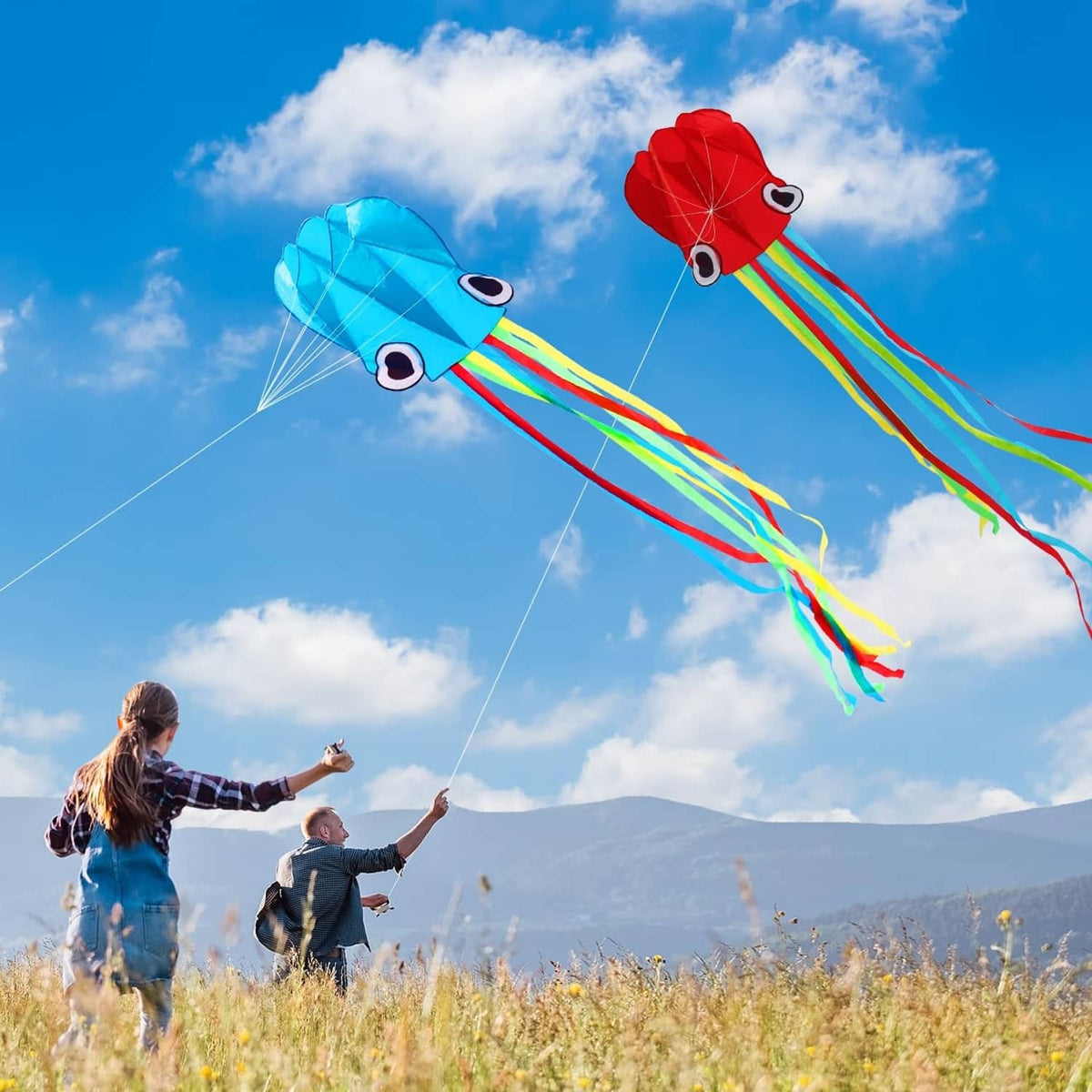 Pair of octopus kites in red and blue with long rainbow tails